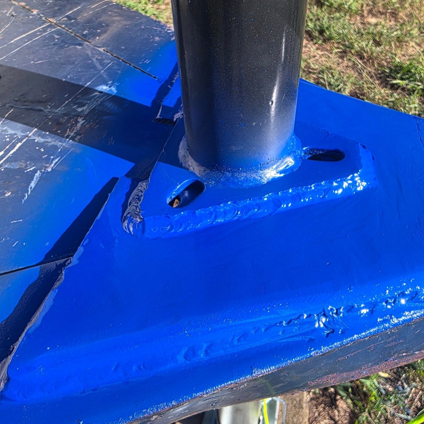 Custom fabricated and painted blue steel base plate with welded supports